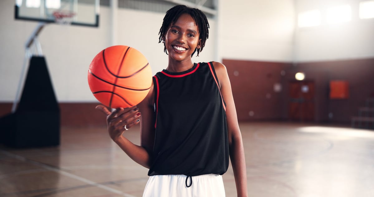 Portrait, basketball and happy black woman at court for sports, workout or practice for training