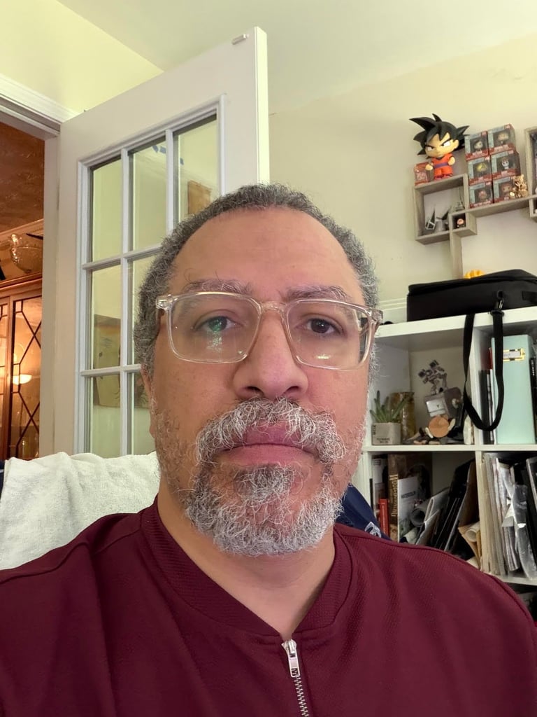 Portrait of Dorian White, Community Builder, with gray beard and glasses wearing a burgundy jacket